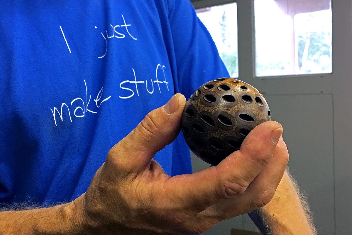 Craig Timmerman showing a wooden sphere